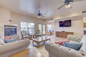 Spacious living room with plenty of seating for the group and natural lighting