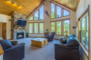 Outstanding living room with 50" TV, fireplace and magnificent windows!