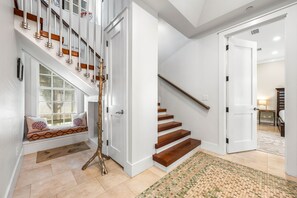 Foyer entry into Casa al Fin, spacious hallway area with laundry room and reading nook under the stairs