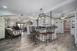Wide angle of LR, DR and kitchen from the front door. 