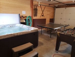 Heated garage game room for comfort and fun.  Includes hot tub, ping pong table.