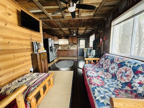 Open floor plan living room kitchen. The futon folds out to a double bed