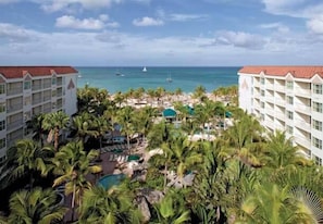 Towering palms, poolside relaxation and world class beach