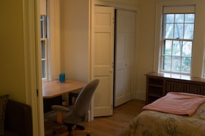 Sleeping area showing desk and closet