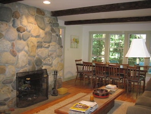 Living room with dining room and stone fireplace