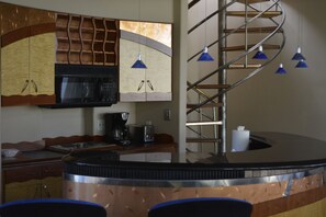 Kitchen/wet-bar area  Circular stairs lead to Sun Deck