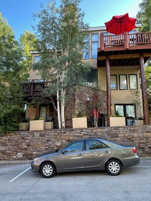Your place is the whole lower level behind the stucco colored planters