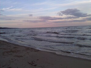 Sunset over the beach at low tide in Autumn.