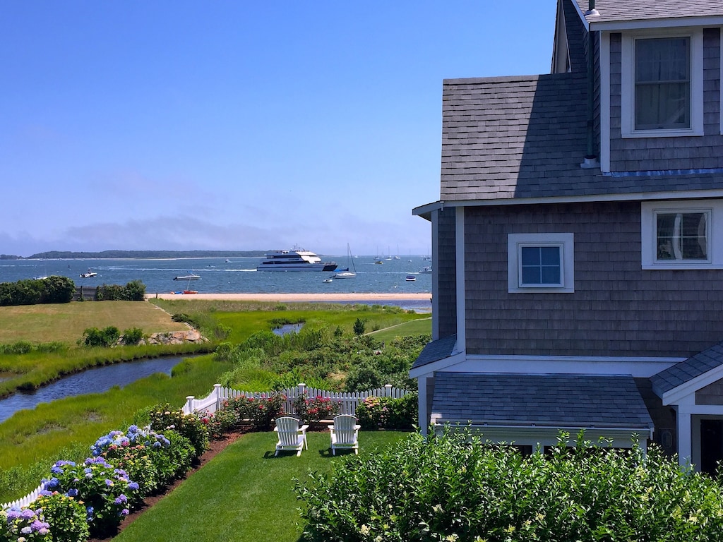 Beautiful view of the harbor from the private fenced in yard of this cottage rental in Massachusetts