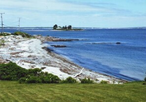 The view of the beach from the house and lawn. 
