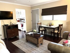 Living area view to kitchen, satellite TV