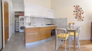 Panoramic Picture of Kitchen & Laundry Closet with Washer/Dryer and Utility Cart