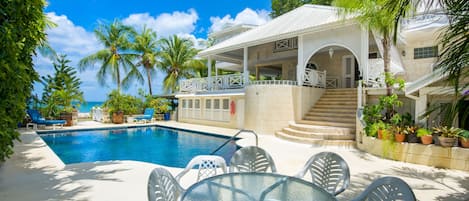 View of the pool and entrance steps looking towards the sea. 