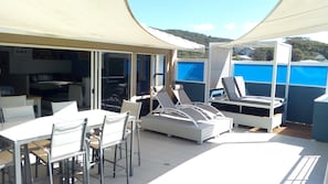 Outdoor dining on the deck overlooking the sand and surf at Boomerang Beach
