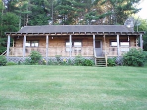 Cabin overlooking meadow and pond.