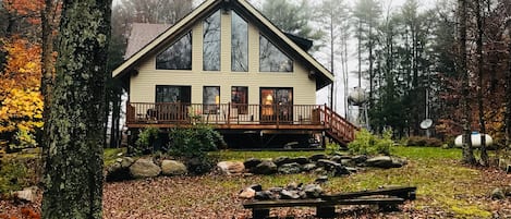 Back of house with deck and fire pit