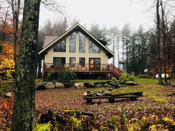 Back of house with deck and fire pit