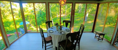 Dine in the fabulous screened in porch. With dining table for 4 & chaise lounger