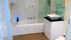 Bathroom with Shower, bath, vanity and Hairdryer