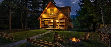 Wilmington Range Chalet twilight with burning campfire in summer