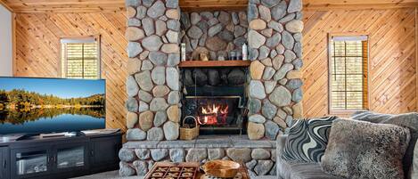Upstairs Living room with a wood burning fireplace, 55" Smart TV, and games