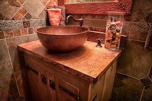 Lower level full bath in Italian stone and copper