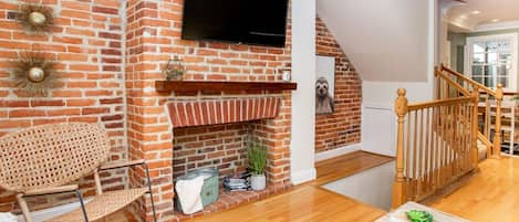 Living room flat screen and exposed brick