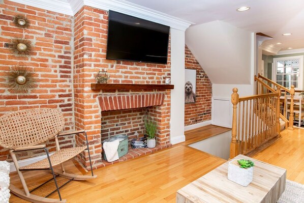 Living room flat screen and exposed brick