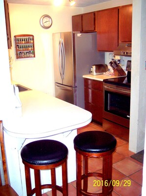 Kitchen off dining area with new stainless appliances. Closet/Pantry adjacent