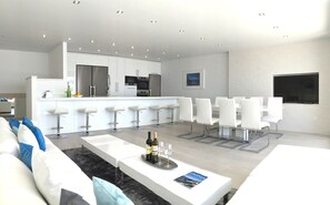 Another View of living/dining/kitchen area. Plenty of seating with 6 barstools.
