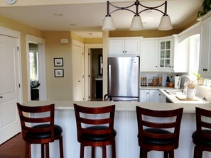 View of kitchen and bar seating 