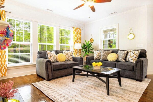 Open floor plan includes a cozy couch and love seat in the living room