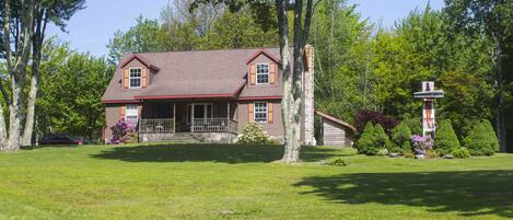 Front of house with one of the sculptures in the yard