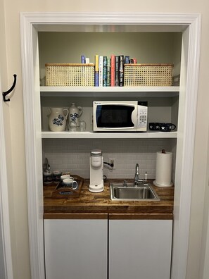 Wet bar with microwave, Keurig coffee maker and lending library 