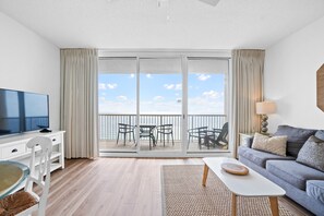 Large living area with ocean views and comfortable queen memory bed pullout