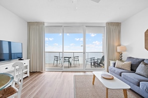 Large living area with ocean views and comfortable queen memory bed pullout