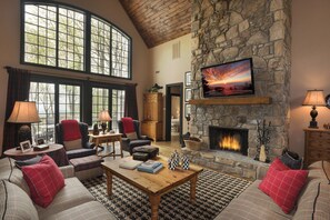 Upstairs living room with large screen TV and freplace