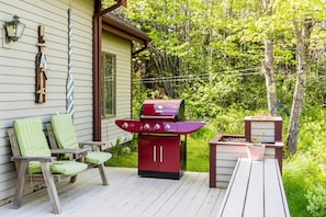Just a small part of the large deck with picnic table, numerous seating and grill overlooking Denning Brook.