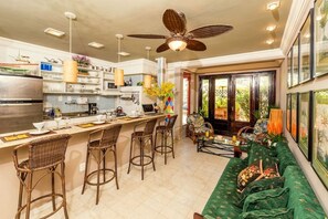 The living room with an open kitchen and doors to the garden terrace 