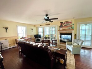 Living room view from the kitchen showing fireplace and seating area.