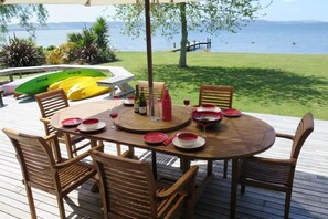 Casual lakeside BBQ area with spa and kayaks inc