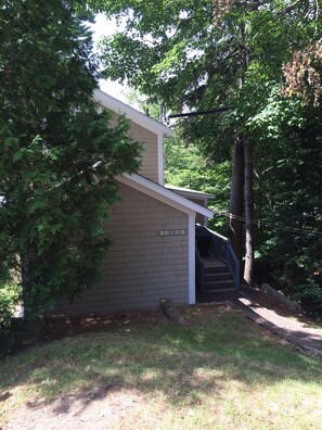 Deck and gas grill at back entrance from parking area