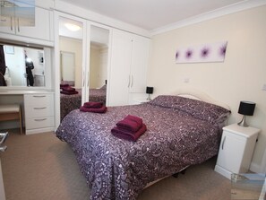 Master bedroom. Built in wardrobe. Ensuite cloakroom. TV. Bedside tables .