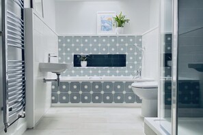 Main bathroom with bath and large walk-in shower.