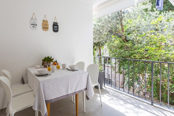 A large covered terrace with afternoon sun and sun shades
