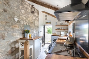 Galley style kitchen with heating under the traditional slate floor.