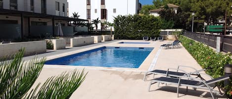 Pool area showing apartment's balcony top right hand corner