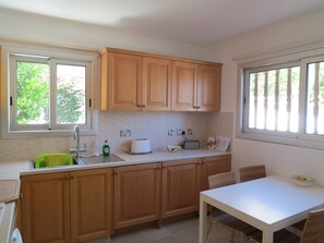 Kitchen with dishwasher, washing machine, fridge/freezer, cooker, hob, microwave