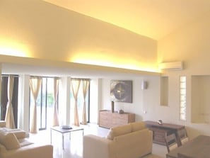 Large Living room leads out onto the pool