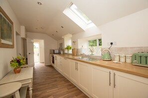 The Kitchen, airy and fully equipped plus utility area as you enter.